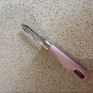 Stainless produce peeler with pink handle